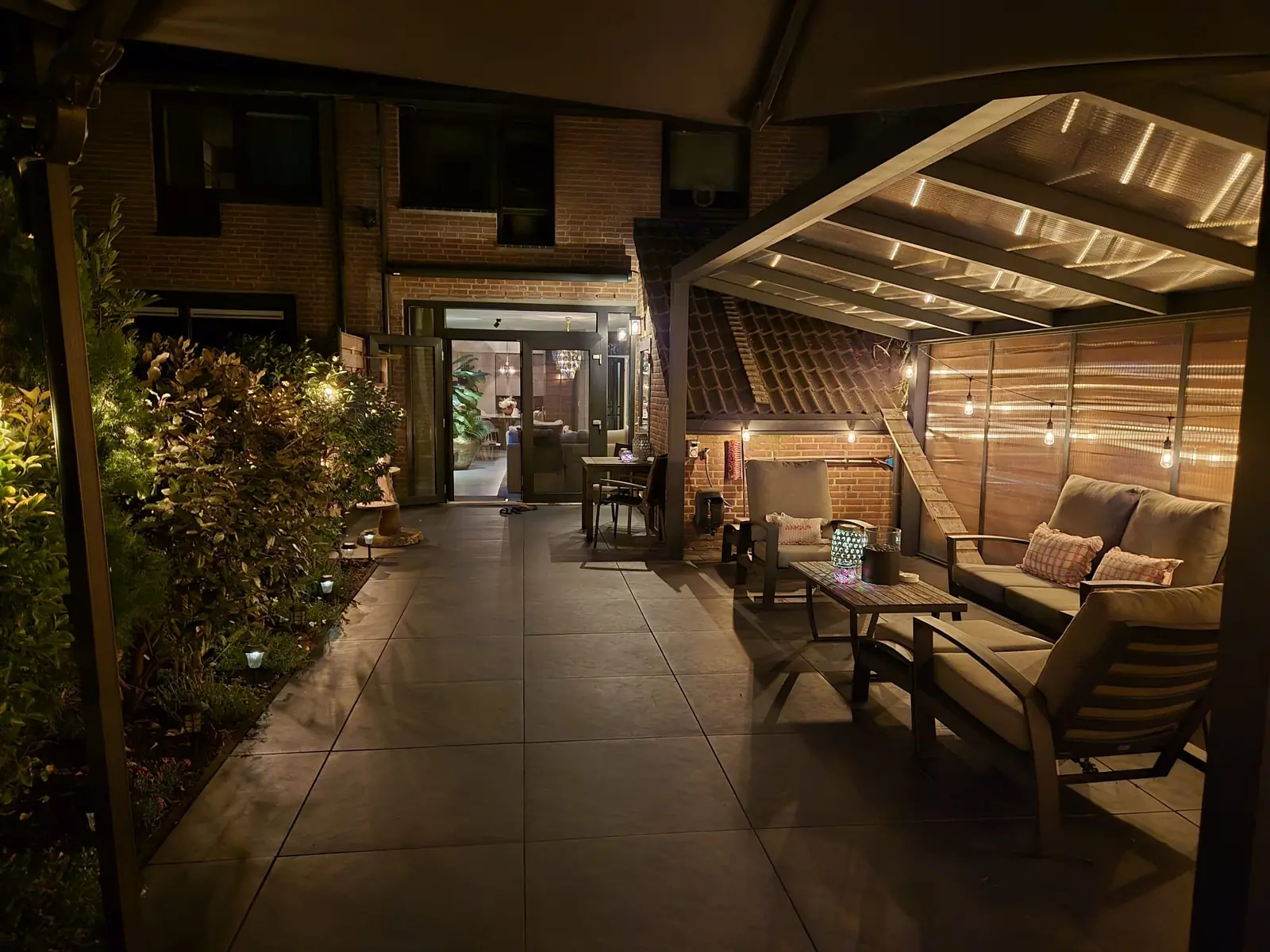 Doorkijk onder de veranda naar de woning